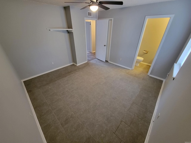 unfurnished bedroom with visible vents, baseboards, ceiling fan, and connected bathroom