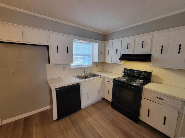 kitchen featuring black appliances, under cabinet range hood, light wood-type flooring, and white cabinets