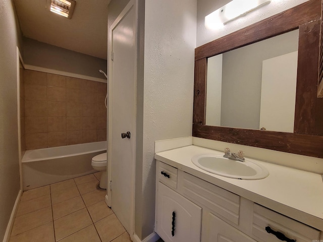 bathroom with baseboards, a textured wall, toilet, tile patterned floors, and vanity