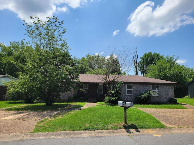 single story home featuring brick siding and a front yard