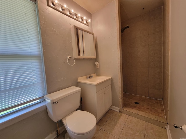 full bath featuring toilet, a stall shower, vanity, and tile patterned floors