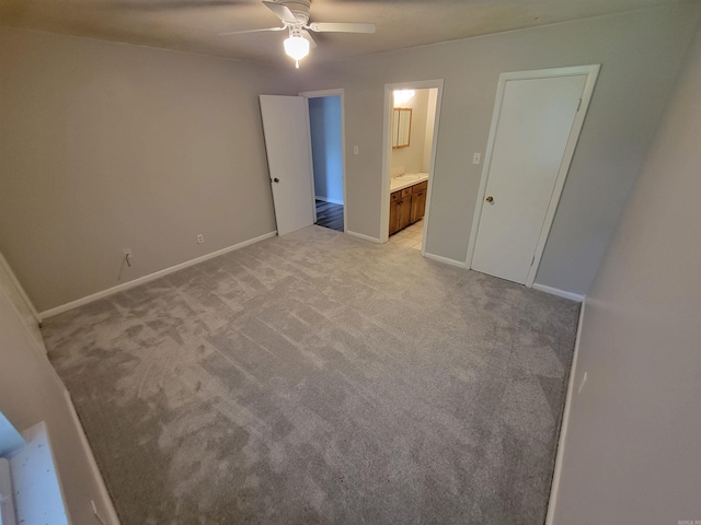 unfurnished bedroom featuring ceiling fan, baseboards, connected bathroom, and light colored carpet