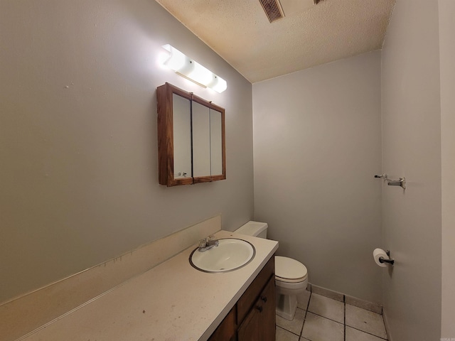 half bathroom with visible vents, toilet, tile patterned flooring, a textured ceiling, and vanity