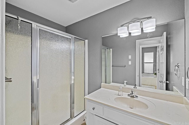 bathroom featuring a stall shower and vanity