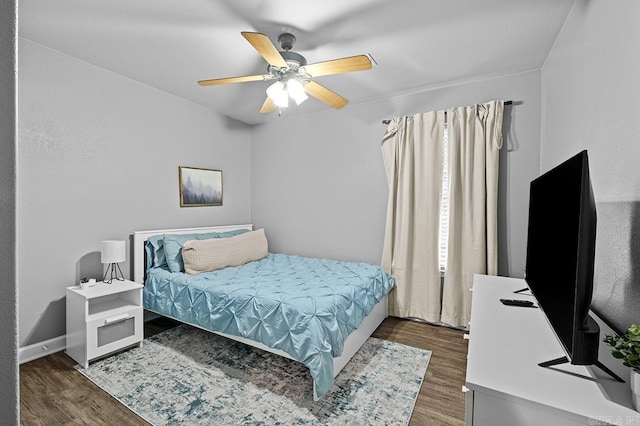 bedroom with baseboards, a ceiling fan, and wood finished floors