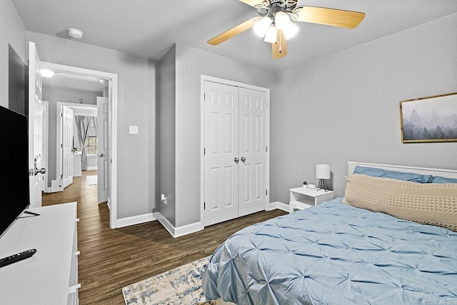 bedroom featuring a closet, ceiling fan, baseboards, and wood finished floors