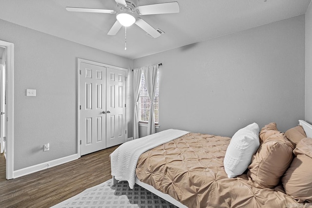 bedroom with a ceiling fan, a closet, baseboards, and wood finished floors