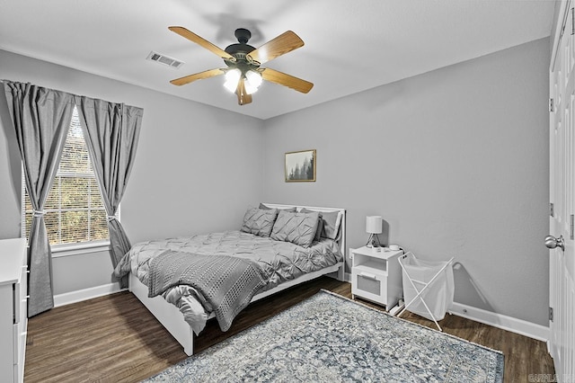 bedroom with visible vents, ceiling fan, baseboards, and wood finished floors