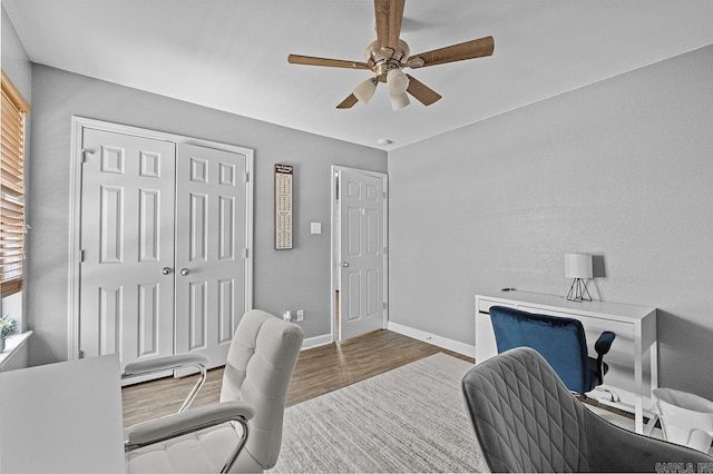 office area featuring ceiling fan, baseboards, and wood finished floors