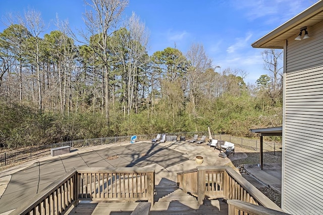 wooden terrace with a patio and fence