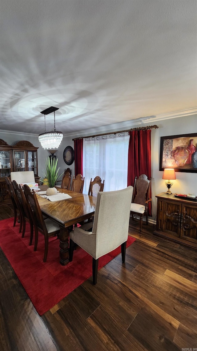 dining area featuring a textured ceiling, ornamental molding, and wood finished floors