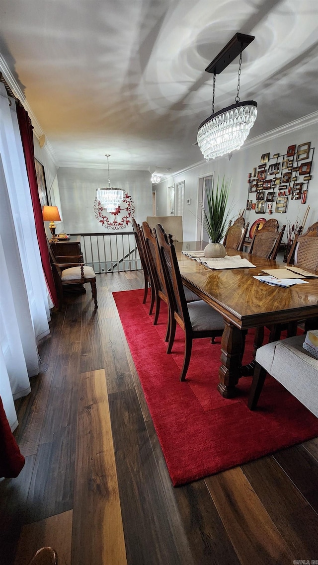 dining room featuring ornamental molding, wood-type flooring, and a notable chandelier