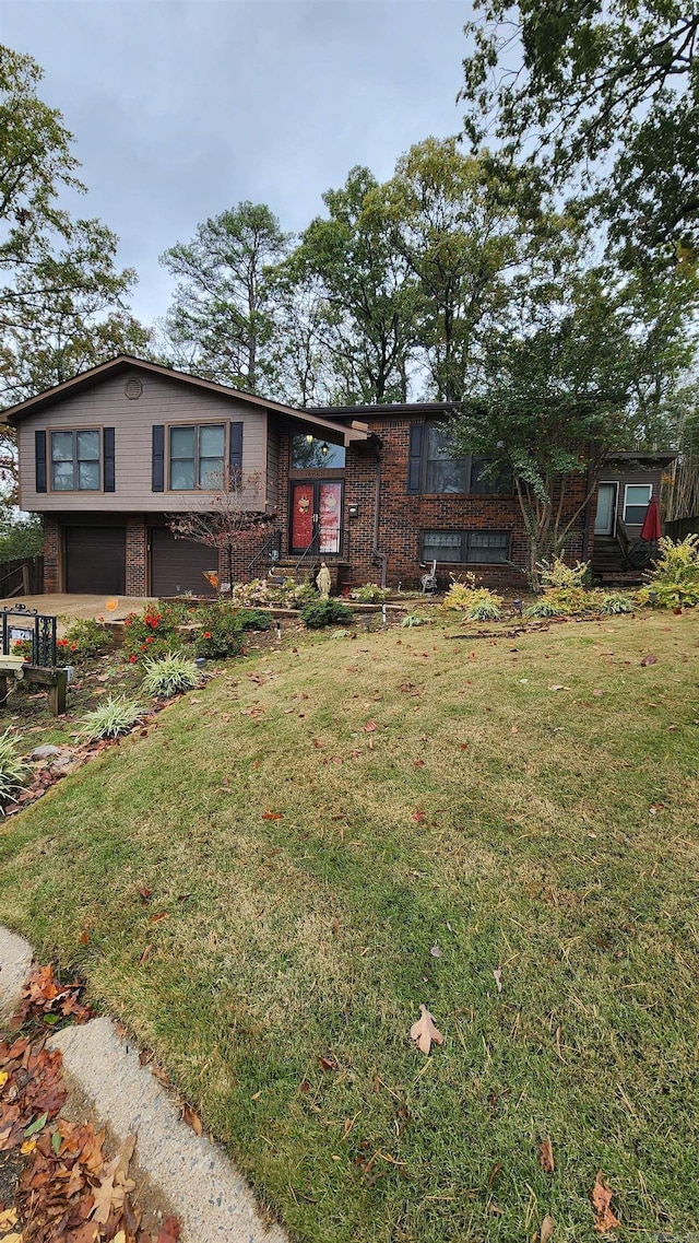 view of front of home with an attached garage, a front lawn, and brick siding