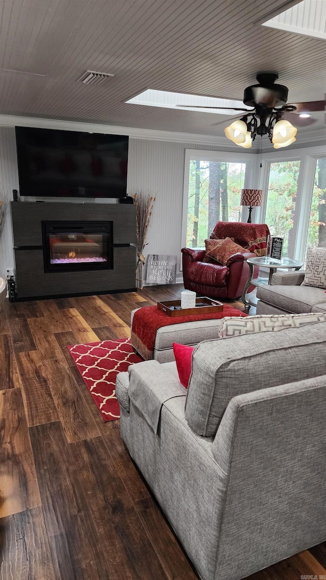 living area with a glass covered fireplace, wooden ceiling, visible vents, and hardwood / wood-style floors