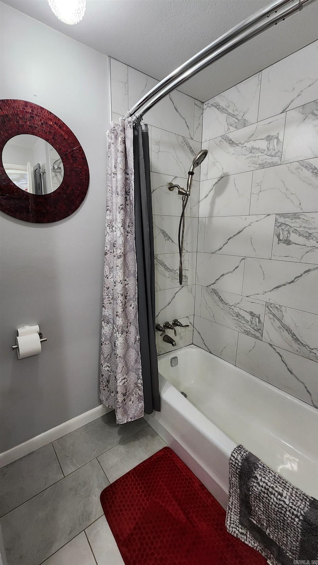 bathroom featuring a textured ceiling, baseboards, and shower / tub combo with curtain