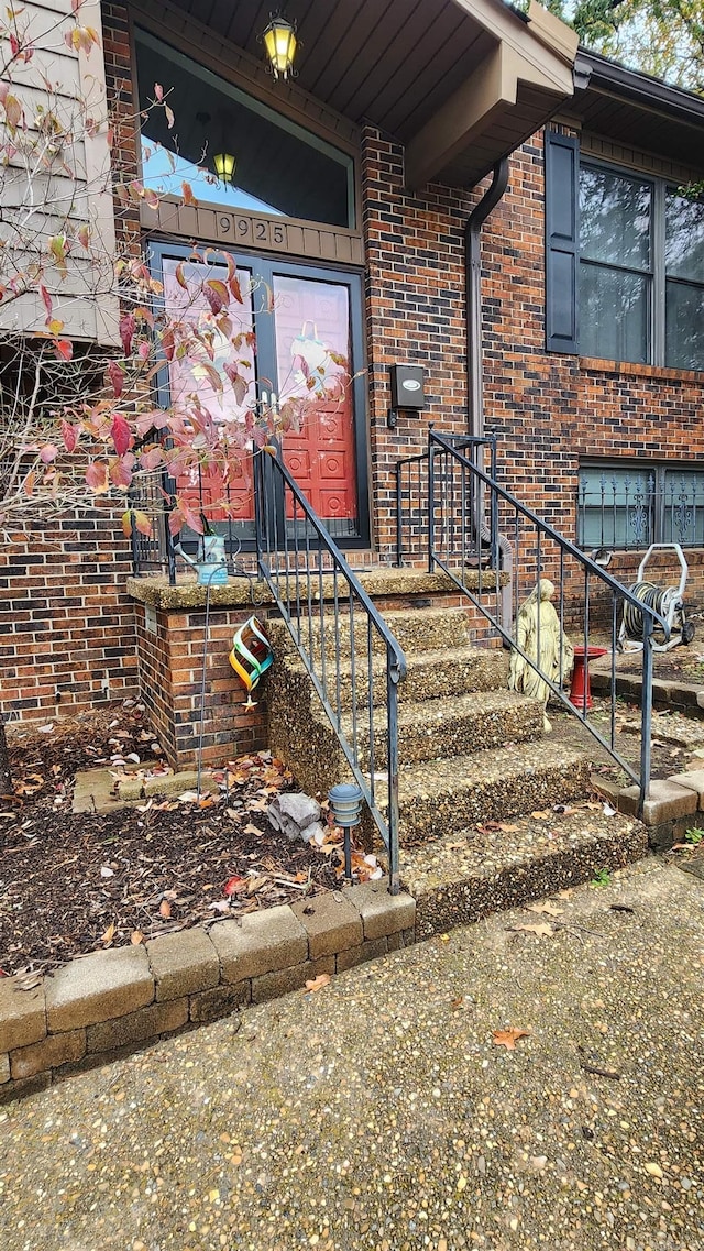 property entrance with brick siding