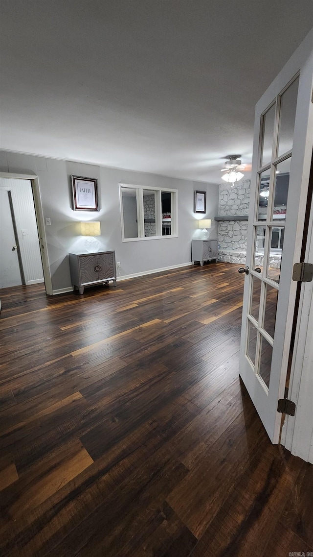 living room with french doors, baseboards, and wood finished floors