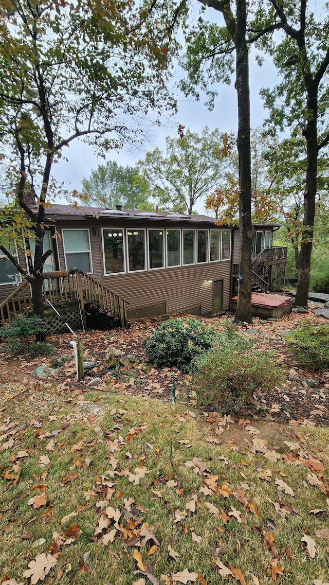 view of front of home with a sunroom and a deck