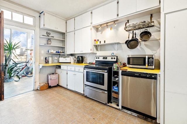 kitchen featuring open shelves, appliances with stainless steel finishes, light countertops, and white cabinets