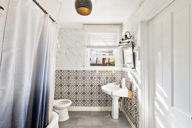 bathroom with a washtub, tile walls, toilet, tile patterned flooring, and a shower with curtain