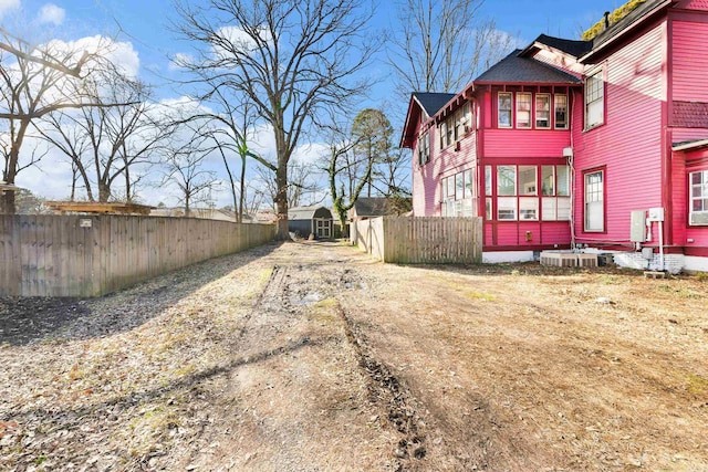 view of side of home with fence