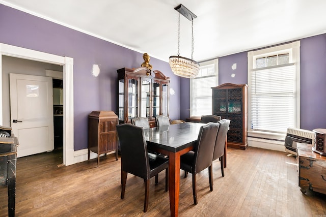 dining area with hardwood / wood-style floors and heating unit