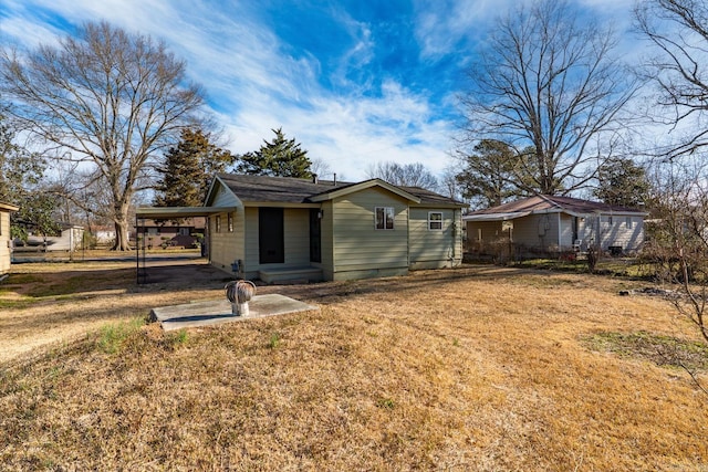 exterior space featuring a carport and a lawn