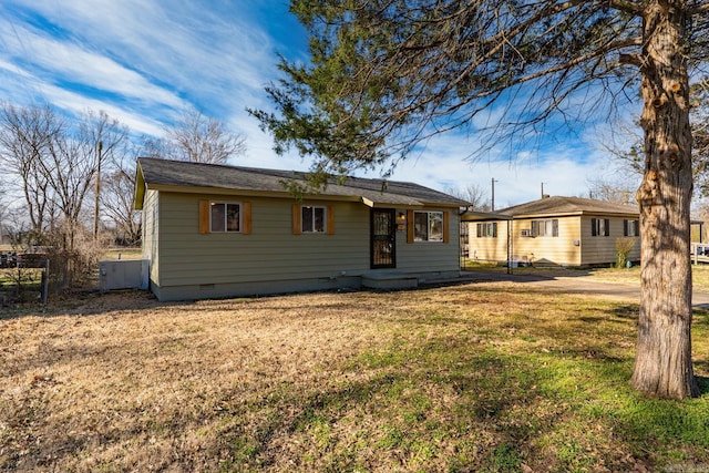 ranch-style home with crawl space, fence, and a front lawn