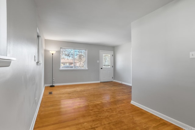 entryway featuring baseboards and wood finished floors