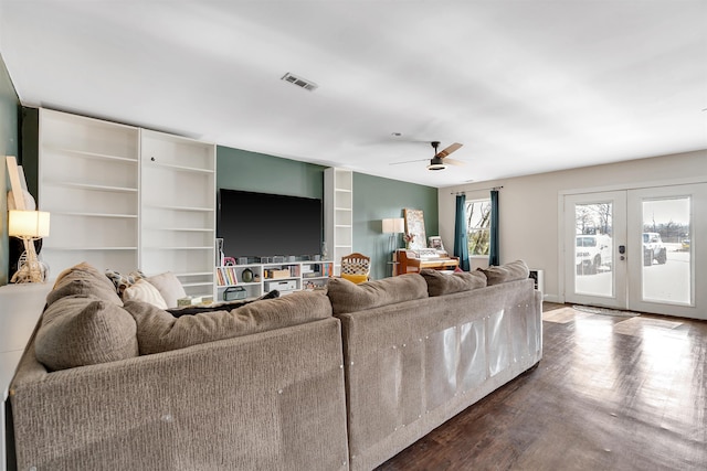 living area featuring dark wood-type flooring, french doors, visible vents, and a ceiling fan