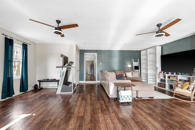 living room with baseboards, a ceiling fan, and wood finished floors