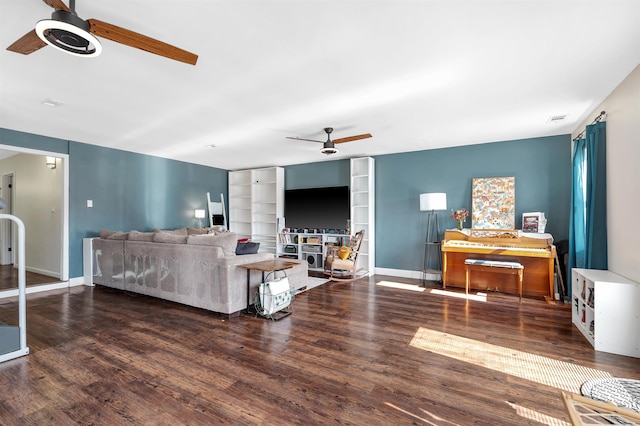 living room with built in shelves, visible vents, ceiling fan, wood finished floors, and baseboards