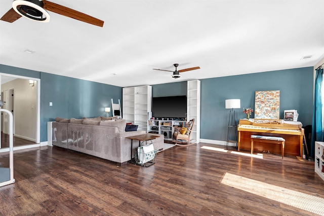 living area featuring ceiling fan, baseboards, and wood finished floors