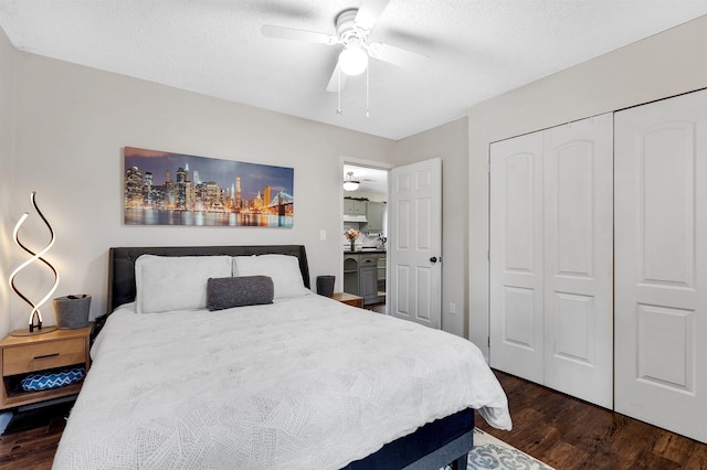 bedroom with dark wood-type flooring, a closet, ceiling fan, and a textured ceiling