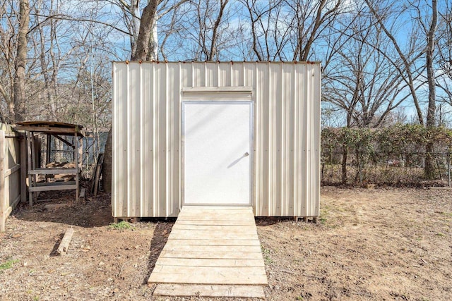 view of shed featuring fence