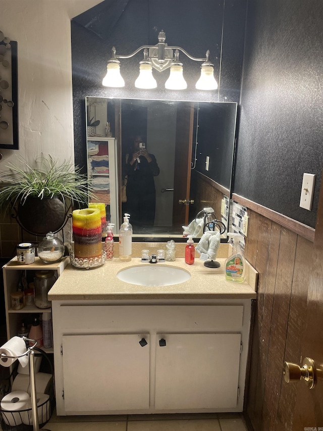 bathroom featuring a textured wall and vanity