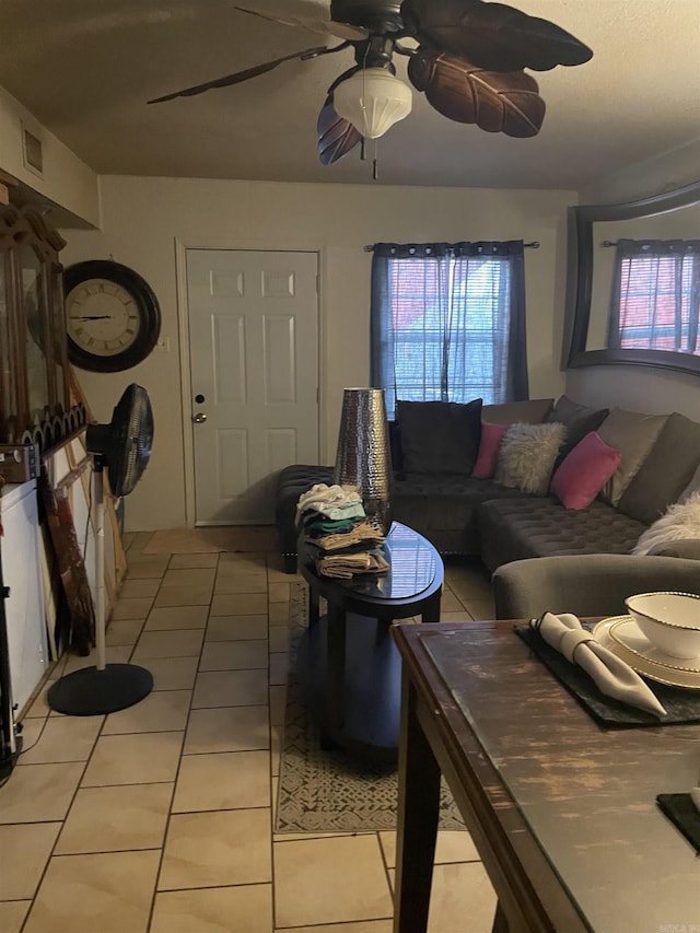 living area featuring light tile patterned floors and a ceiling fan