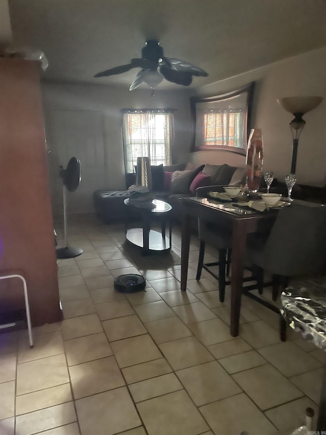 living room featuring light tile patterned floors and ceiling fan