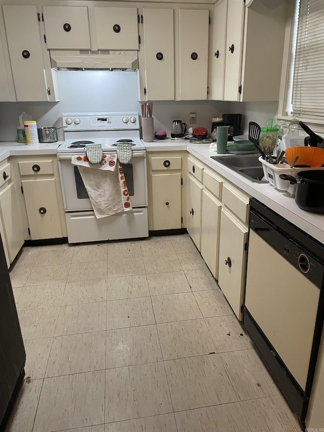 kitchen featuring white appliances, under cabinet range hood, light countertops, and a sink