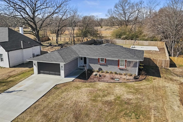 single story home featuring driveway, an attached garage, fence, and a front yard