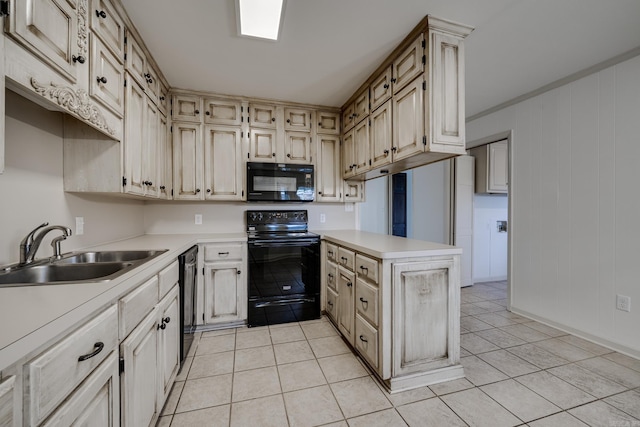 kitchen with light countertops, a sink, a peninsula, and black appliances