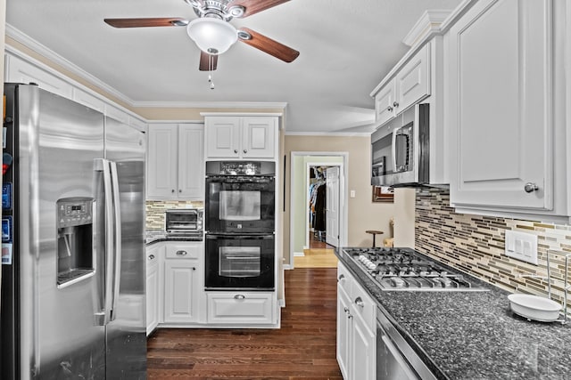 kitchen with stainless steel appliances, ornamental molding, dark wood-style flooring, and white cabinetry