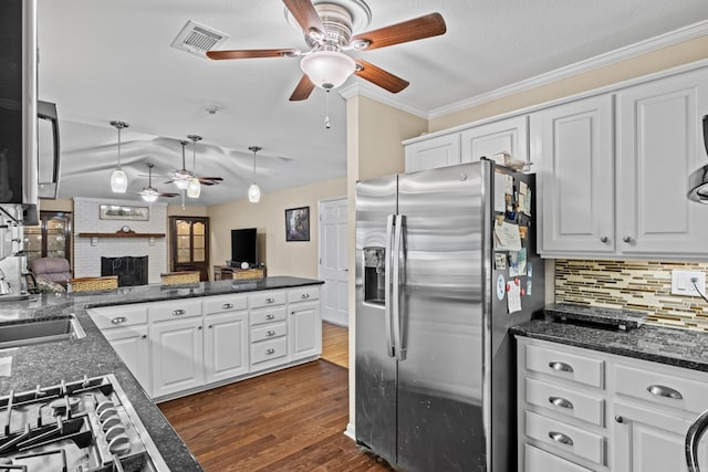 kitchen featuring visible vents, white cabinets, dark wood finished floors, stainless steel appliances, and crown molding