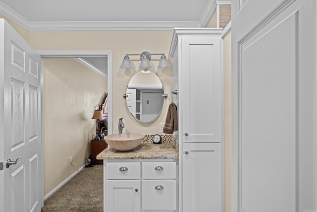 bathroom featuring baseboards, crown molding, and vanity