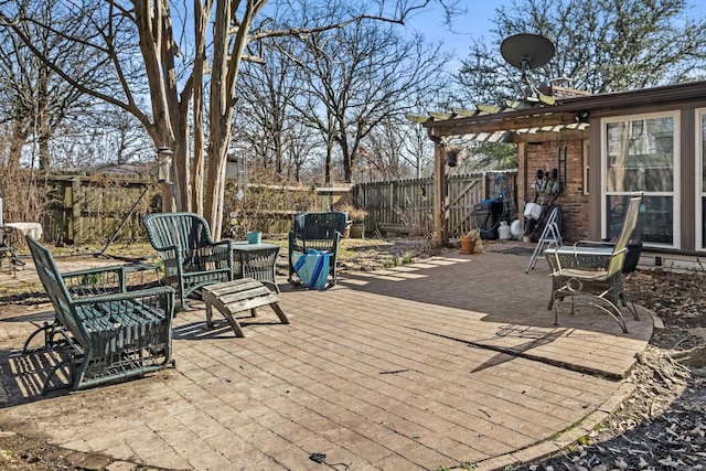 view of patio / terrace with a deck, a fenced backyard, and a pergola