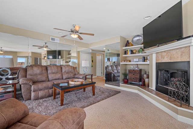 101 Long Island Dr Unit 202, Hot Springs National Park, AR 71913 - carpeted living area with a tiled fireplace, visible vents, and baseboards
