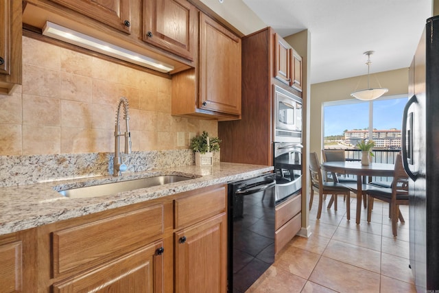 101 Long Island Dr Unit 202, Hot Springs National Park, AR 71913 - kitchen featuring brown cabinets, decorative backsplash, light tile patterned flooring, a sink, and black appliances