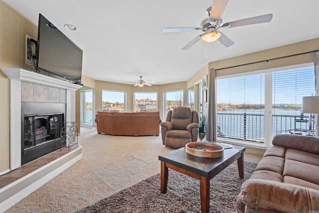 101 Long Island Dr Unit 202, Hot Springs National Park, AR 71913 - carpeted living area featuring a ceiling fan, a fireplace with raised hearth, plenty of natural light, and a water view