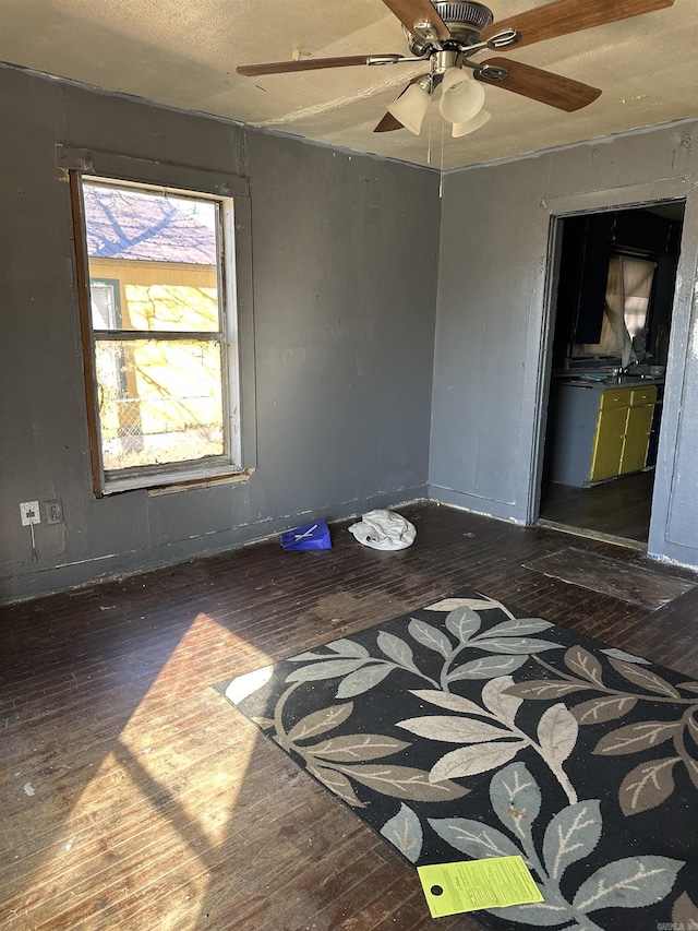 empty room featuring hardwood / wood-style flooring and ceiling fan