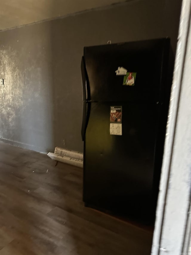 interior details with wood finished floors and freestanding refrigerator